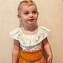 Romy participe au concours pour gagner de l'argent avec cette photo : toddler, child, girl, smiling, standing, white_top, yellow_skirt, short_hair, blue_eyes, indoor, plain_wall, cute, happy, portrait, fashion, clothing, person, young_child, innocent, casual