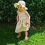 Romy participe au concours pour gagner de l'argent avec cette photo : toddler, child, dress, hat, purse, outdoor, grass, greenery, sunlight, sandals, person, smile, nature, leaves, young, fashion, summer, cute, portrait, garden