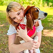 Duke joined the competition — help win amazing prizes! woman, dog, hugging, outdoor, cowboy_hat, bandana, pet, affection, nature, greenery, sunlight, casual_clothing, white_dress, brown_and_white_dog, close_up, portrait, smiling, animal, friendship, relaxation