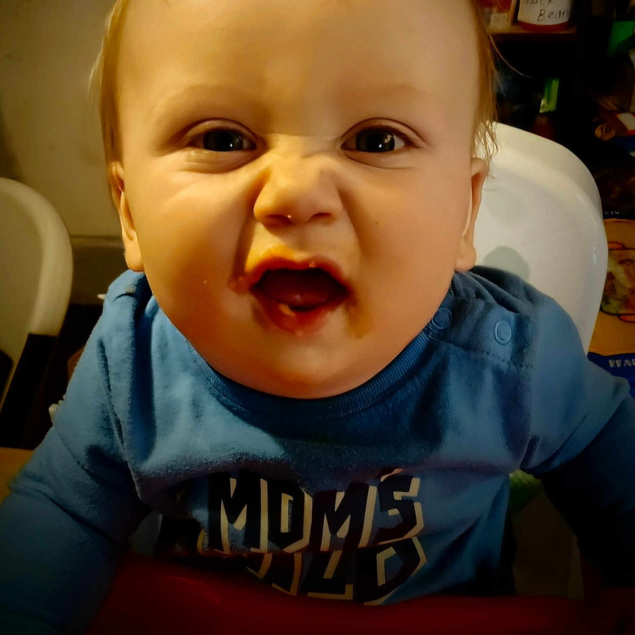 Mikia joined the competition — help win amazing prizes! baby, blue_shirt, child, clothing, container, expression, face, food, funny_expression, hair, high_chair, indoor, kitchen, light, mouth_open, person, portrait, scrunched_nose, seat, table