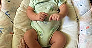 Jacob joined the competition — help win amazing prizes! baby, infant, onesie, smiling, happy, sitting, baby_seat, cushion, pattern, floral, indoor, child, cute, skin, person, young, small, foot, hand, face