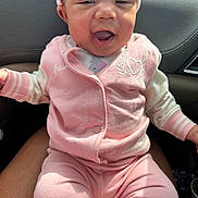 Sariyah is registered to the contest to win money with this photo: baby, pink_outfit, hat, smiling, child, infant, car_interior, seat, sunlight, clothing, cute, happy, person, portrait, sitting, face, skin, headwear, casual, warm