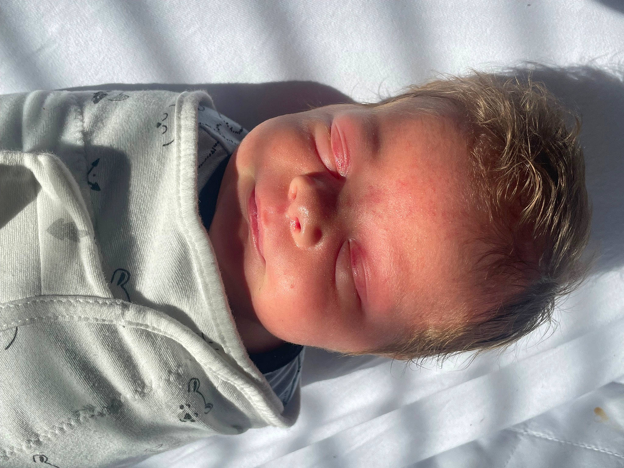 Declan is registered to the contest to win money with this photo: arm, baby, baby_sleeping, baby_toddler_clothing, cheek, comfort, ear, eye, eyebrow, eyelash, finger, forehead, human_body, iris, lip, mouth, nose, person, skin, sleeve