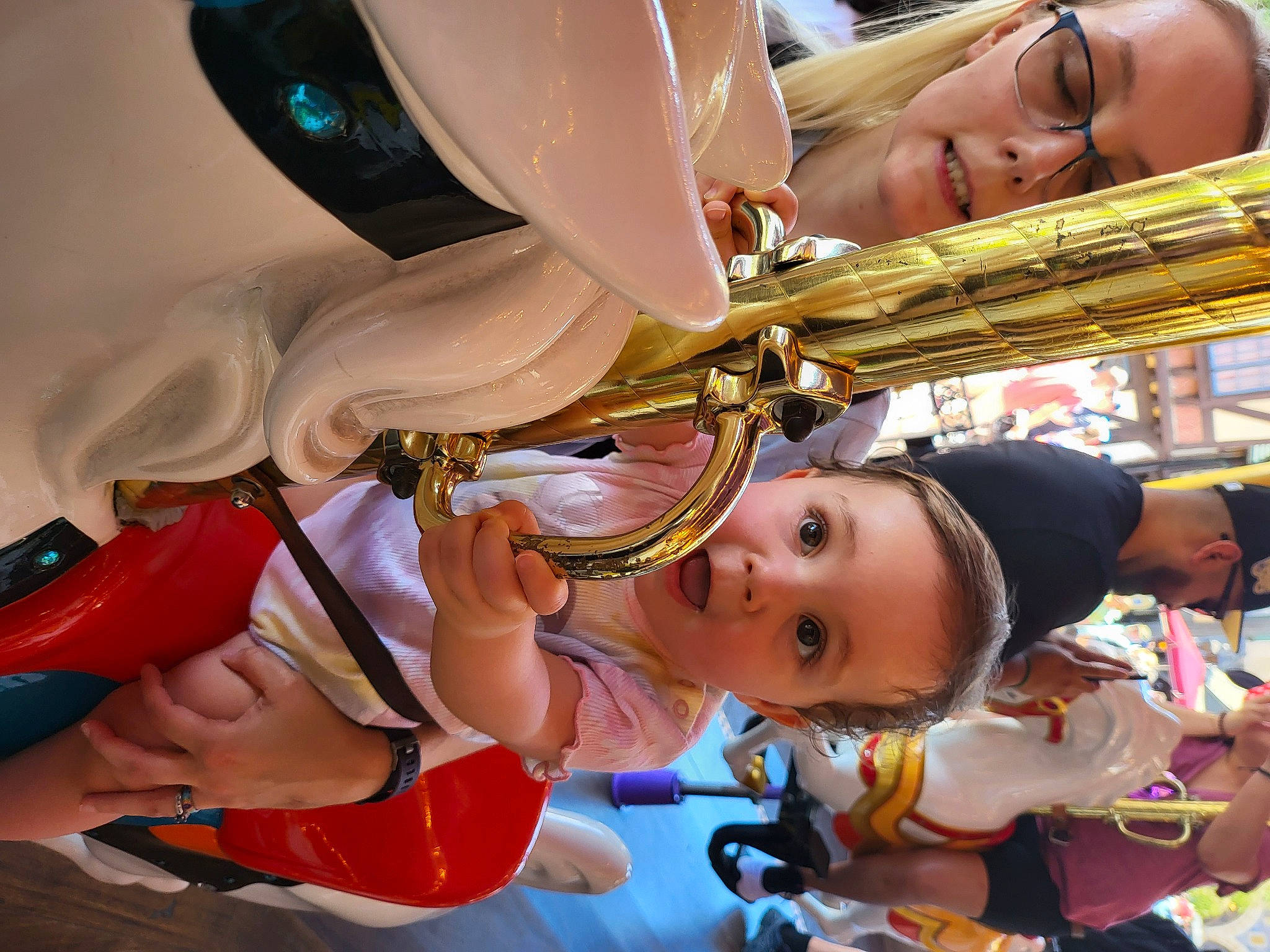 Zoriya is registered to the contest to win money with this photo: amusement_park, amusement_ride, child, event, fun, headwear, helmet, leisure, person, personal_protective_equipment, recreation, surprise, thigh, toddler, wind_instrument