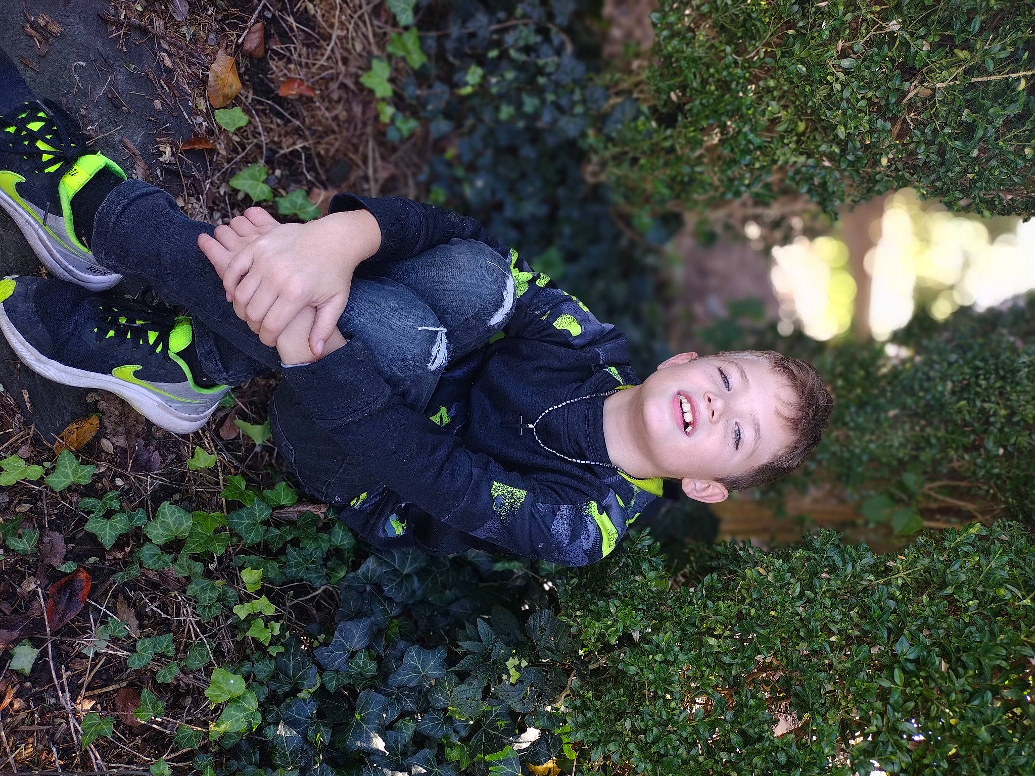 Cyrus is registered to the contest to win money with this photo: child, electric_blue, flash_photography, forest, fun, garden, grass, happy, human_leg, leisure, people_in_nature, person, personal_protective_equipment, plant, portrait_photography, sitting, sock, soil, thigh, toddler