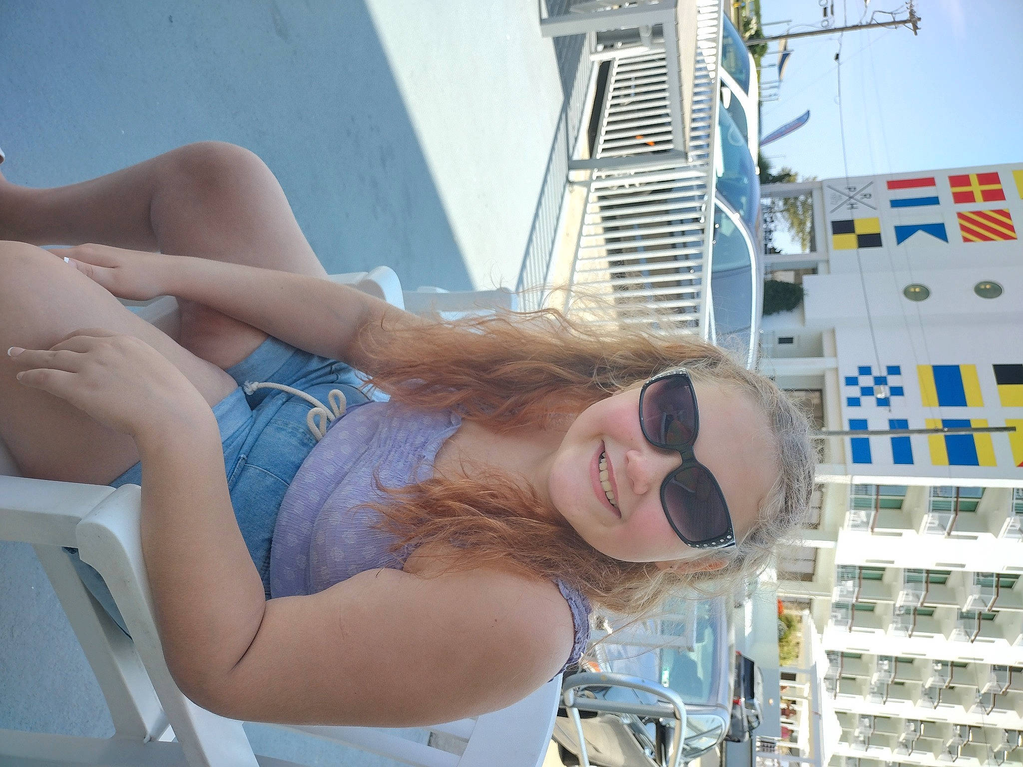 Jaidynn is registered to the contest to win money with this photo: abdomen, elbow, eyewear, fun, goggles, human_leg, joy, leisure, naval_architecture, person, photograph, sitting, sky, smile, summer, sunglasses, thigh, tourism, tower_block, travel