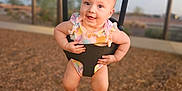 Gracie joined the competition — help win amazing prizes! baby, child, swing, playground, smiling, outdoor, woodchips, clothing, happy, person, summer, fun, daylight, park, seat, infant, babywear, play, activity, joy