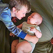 Mathias joined the competition — help win amazing prizes! baby, child, sibling, hug, smile, face, infant, love, family, cuddle, bed, blanket, skin, clothing, happy, toddler, interaction, indoor, person, cute