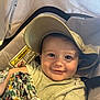 Jules a rejoint le concours — aidez-le/la à gagner de superbes lots ! baby, child, smiling, cap, hat, stroller, blanket, clothing, face, person, infant, cute, happy, portrait, indoor, warning_label, seat, baby_clothes, holding, close_up