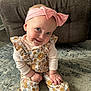 accessories, baby, bracelet, clothing, couch, cushion, face, furniture, happy, head, headband, homedecor, jewelry, pants, person, photography, portrait, sitting, sleeve, smile