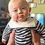 baby, blue_eyes, blurred_background, casual, child, chubby_cheeks, cute, expression, face, hands, holding, home, indoor, infant, person, portrait, sailor_outfit, soft_light, striped_clothing, young_child