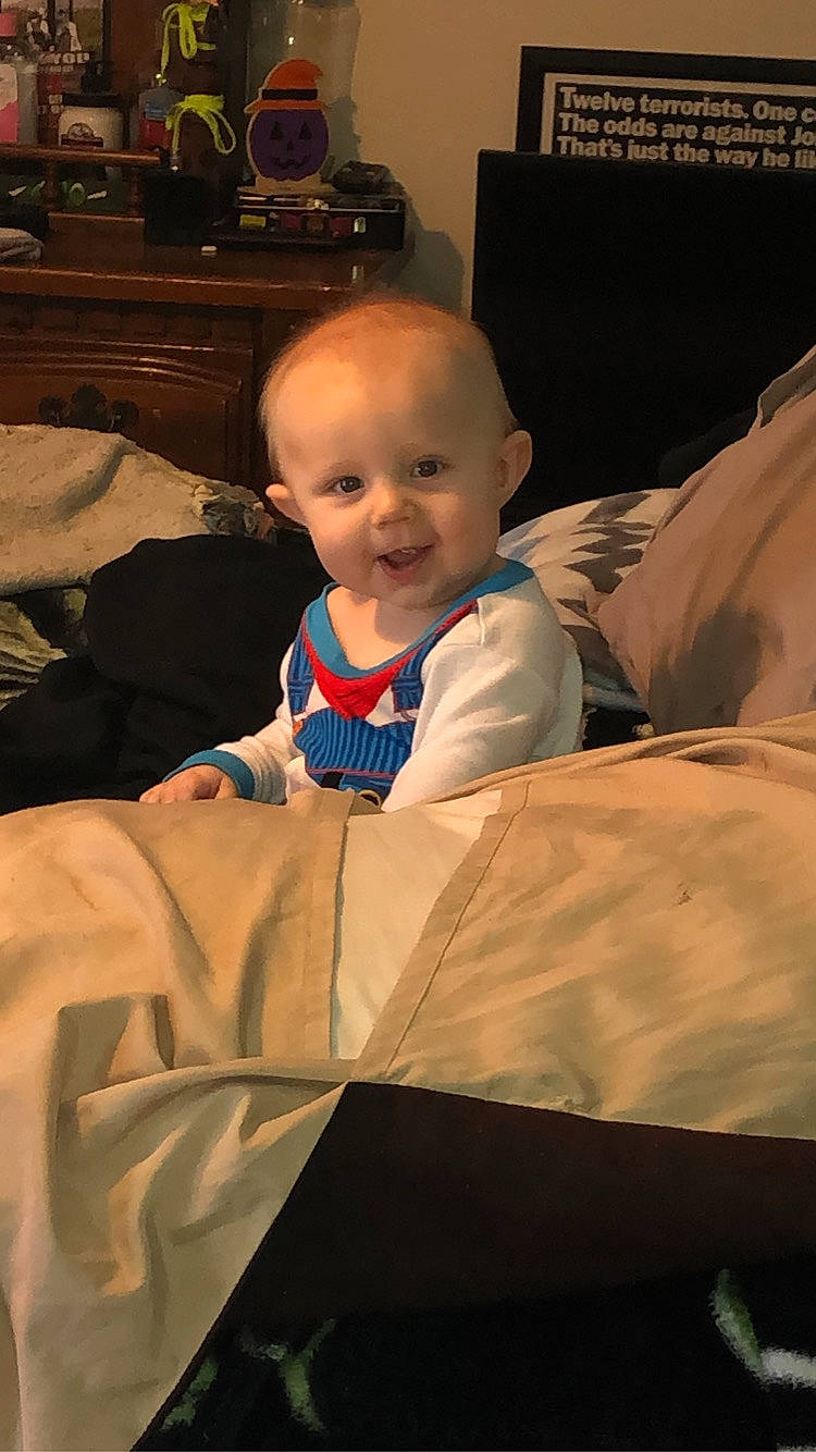 Deacon is registered to the contest to win money with this photo: baby, baby_toddler_clothing, chest_of_drawers, child, comfort, couch, drawer, event, fun, happy, home_appliance, lamp, living_room, person, picture_frame, room, sitting, smile, standing, television