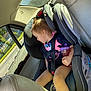 Izabella joined the competition — help win amazing prizes! toddler, child, car_seat, sleeping, sippy_cup, car_interior, seatbelt, sunlight, window, road, vehicle, seat, safety, young_child, casual_clothing, daytime, relaxed, travel, transportation, portrait