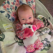 Eralia joined the competition — help win amazing prizes! baby, infant, smiling, plush_toy, blanket, floral_pattern, seated, indoor, cute, happy, child, soft_toy, car_seat, cozy, pink, clothing, face, person, toy, young