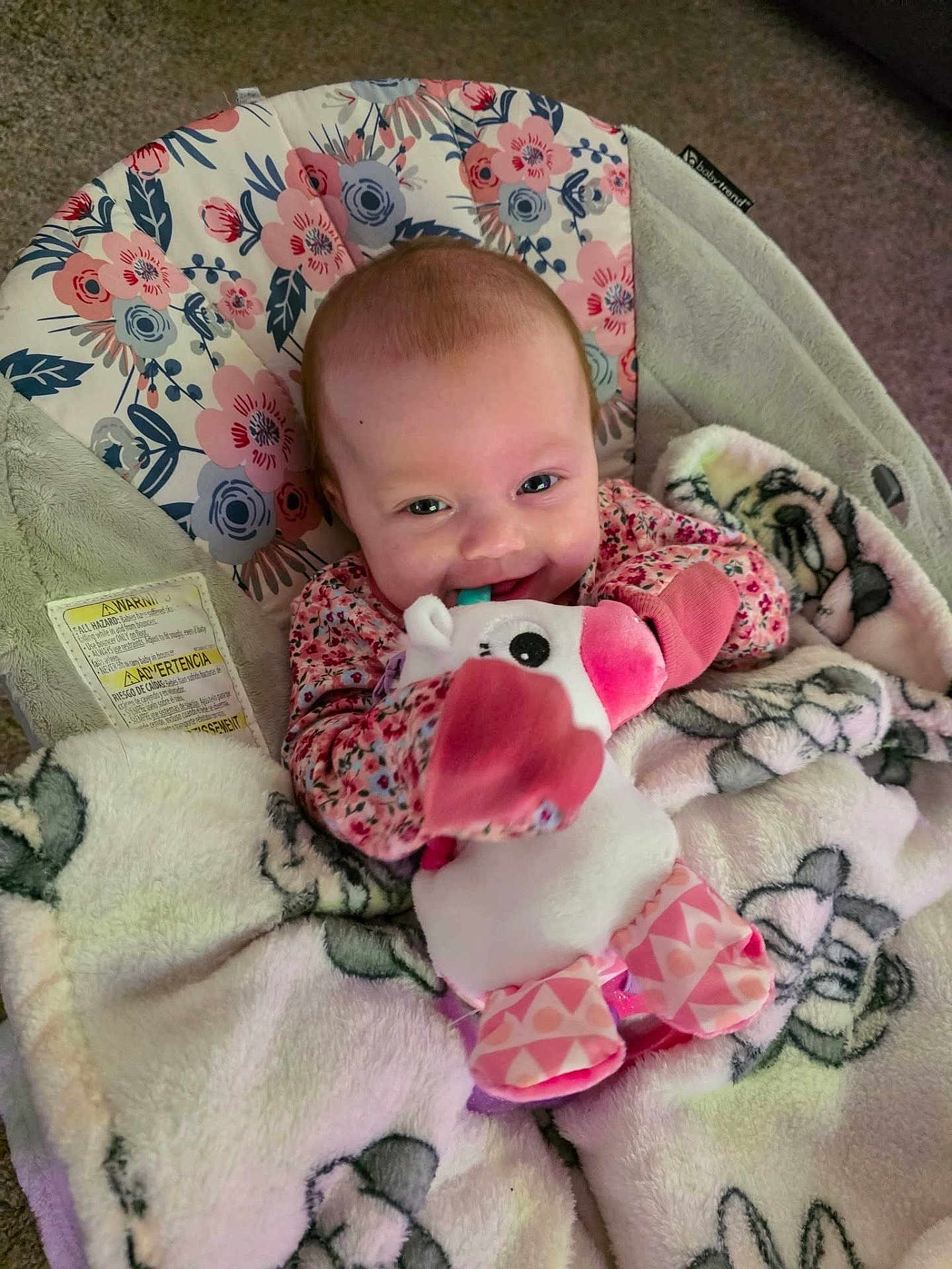 Eralia joined the competition — help win amazing prizes! baby, infant, smiling, plush_toy, blanket, floral_pattern, seated, indoor, cute, happy, child, soft_toy, car_seat, cozy, pink, clothing, face, person, toy, young