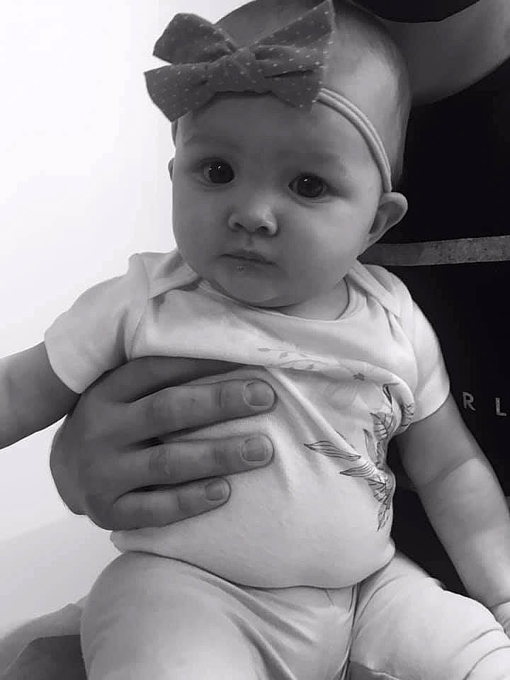 Kehlani is registered to the contest to win money with this photo: arm, baby, baby_toddler_clothing, cap, cheek, costume_hat, eye, eyebrow, finger, gesture, hand, head, headgear, headwear, human_body, lip, neck, person, skin, stomach