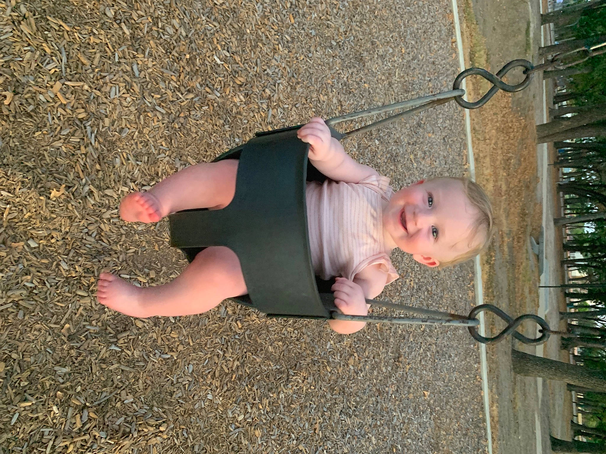 Brynleigh is registered to the contest to win money with this photo: asphalt, baby, foot, fun, grass, hand, human_leg, joy, knee, leg, leisure, people_in_nature, person, road_surface, sidewalk, sitting, smile, soil, thigh, toddler