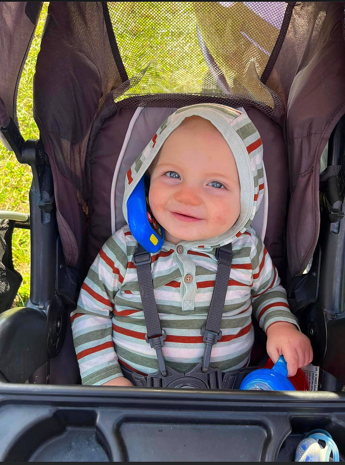 Brady is registered to the contest to win money with this photo: auto_part, automotive_design, automotive_exterior, baby, baby_carriage, baby_products, baby_safety, baby_toddler_clothing, car_seat, child, comfort, electric_blue, eye, fun, headwear, joy, motor_vehicle, person, product, sitting