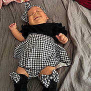 Emilia joined the competition — help win amazing prizes! baby, infant, smile, sleeping, bed, blanket, headband, bow, black_and_white, clothing, skirt, socks, legs, cute, peaceful, indoors, toddler, person, fabric, soft