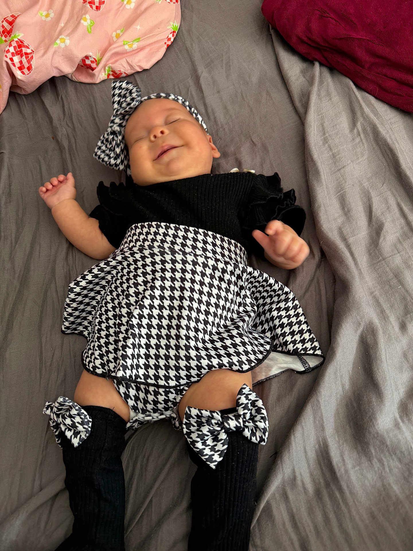 Emilia joined the competition — help win amazing prizes! baby, infant, smile, sleeping, bed, blanket, headband, bow, black_and_white, clothing, skirt, socks, legs, cute, peaceful, indoors, toddler, person, fabric, soft