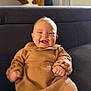 baby, child, smiling, happy, sitting, couch, indoor, knit_dress, tights, furniture, stairs, home_interior, wood, portrait, cute, infant, person, cozy, warm, face