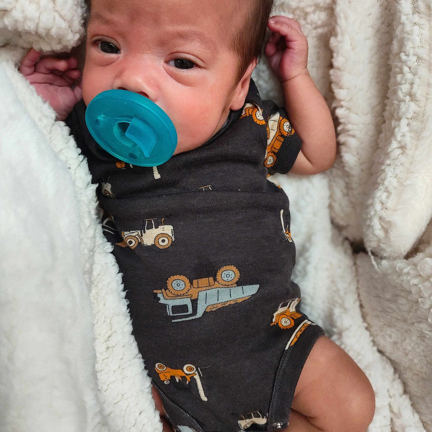 Landon is registered to the contest to win money with this photo: baby, blanket, bodypart, clothing, couch, face, finger, furniture, hand, head, homedecor, hoodie, knitwear, newborn, person, photography, portrait, sweater, sweatshirt, towel