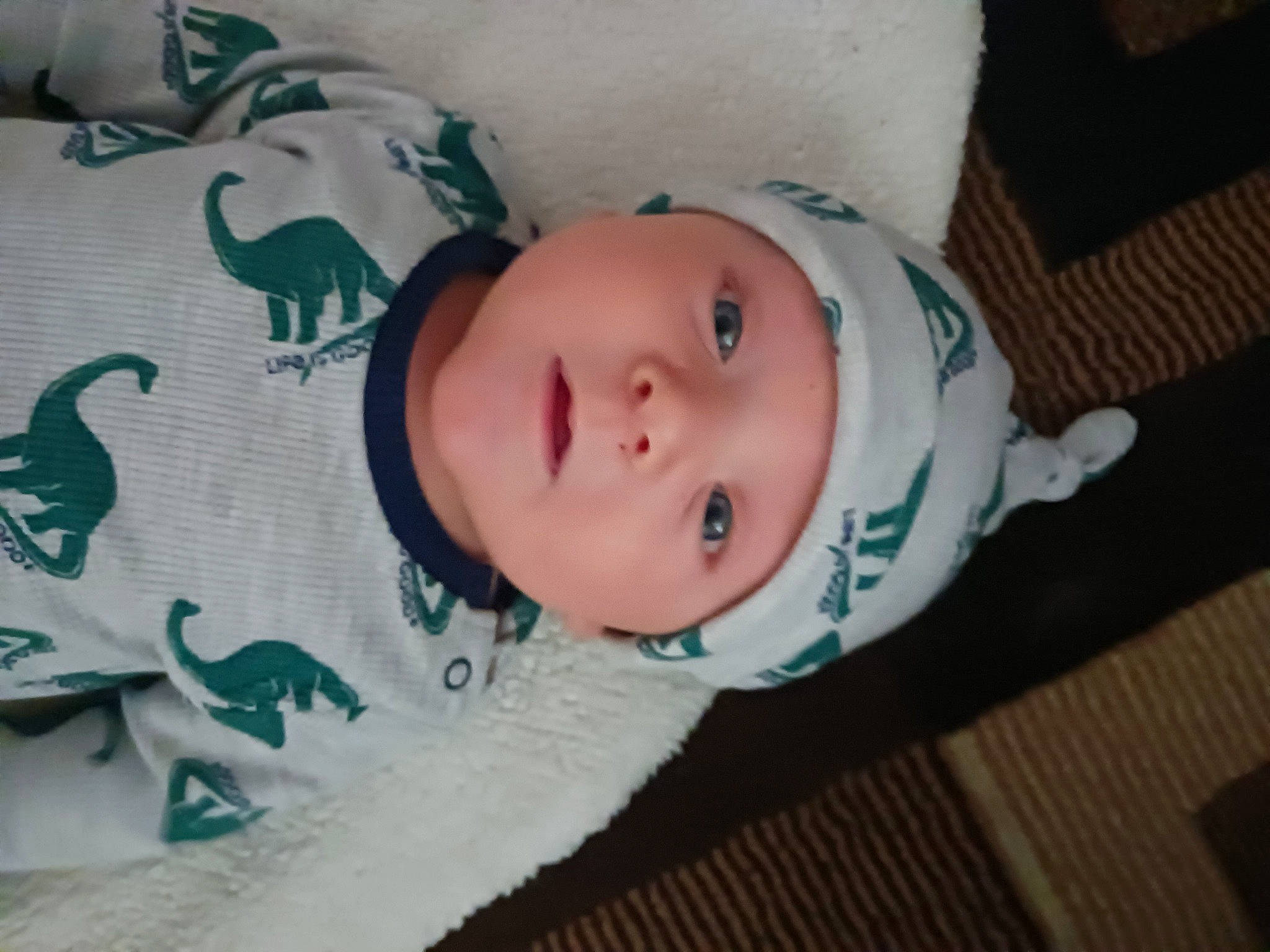 Josiah joined the competition — help win amazing prizes! baby, baby_toddler_clothing, cheek, child, eye, eyelash, face, flooring, hardwood, head, headwear, iris, linens, nose, pattern, person, sleeve, smile, toddler, wood