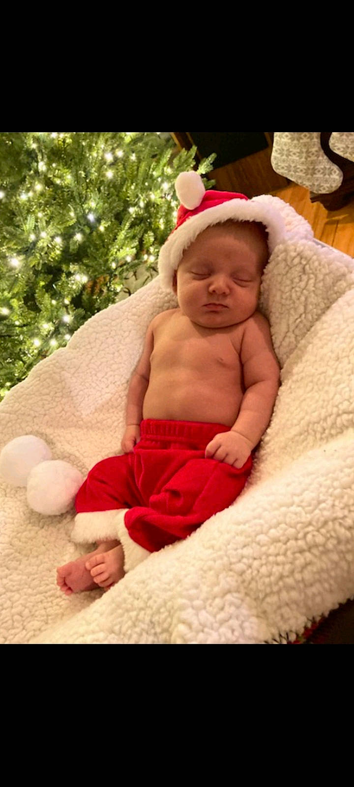 Josiah is registered to the contest to win money with this photo: abdomen, baby, baby_sleeping, baby_toddler_clothing, child, comfort, event, finger, foot, fur, happy, holiday, linens, magenta, person, pink, room, sitting, skin, thumb