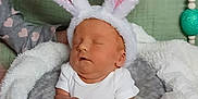 Raelynn joined the competition — help win amazing prizes! baby, sleeping, bunny_ears, costume, blanket, purple_bowl, infant, cute, cozy, soft, child, hands, pink, white, gray, green_background, nursery, resting, adorable, peaceful