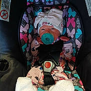 Raelynn joined the competition — help win amazing prizes! baby, car_seat, pacifier, hat, bow, infant, clothing, patterned, butterfly, seatbelt, socks, pink, purple, blue, black, white, cute, child, newborn, sitting