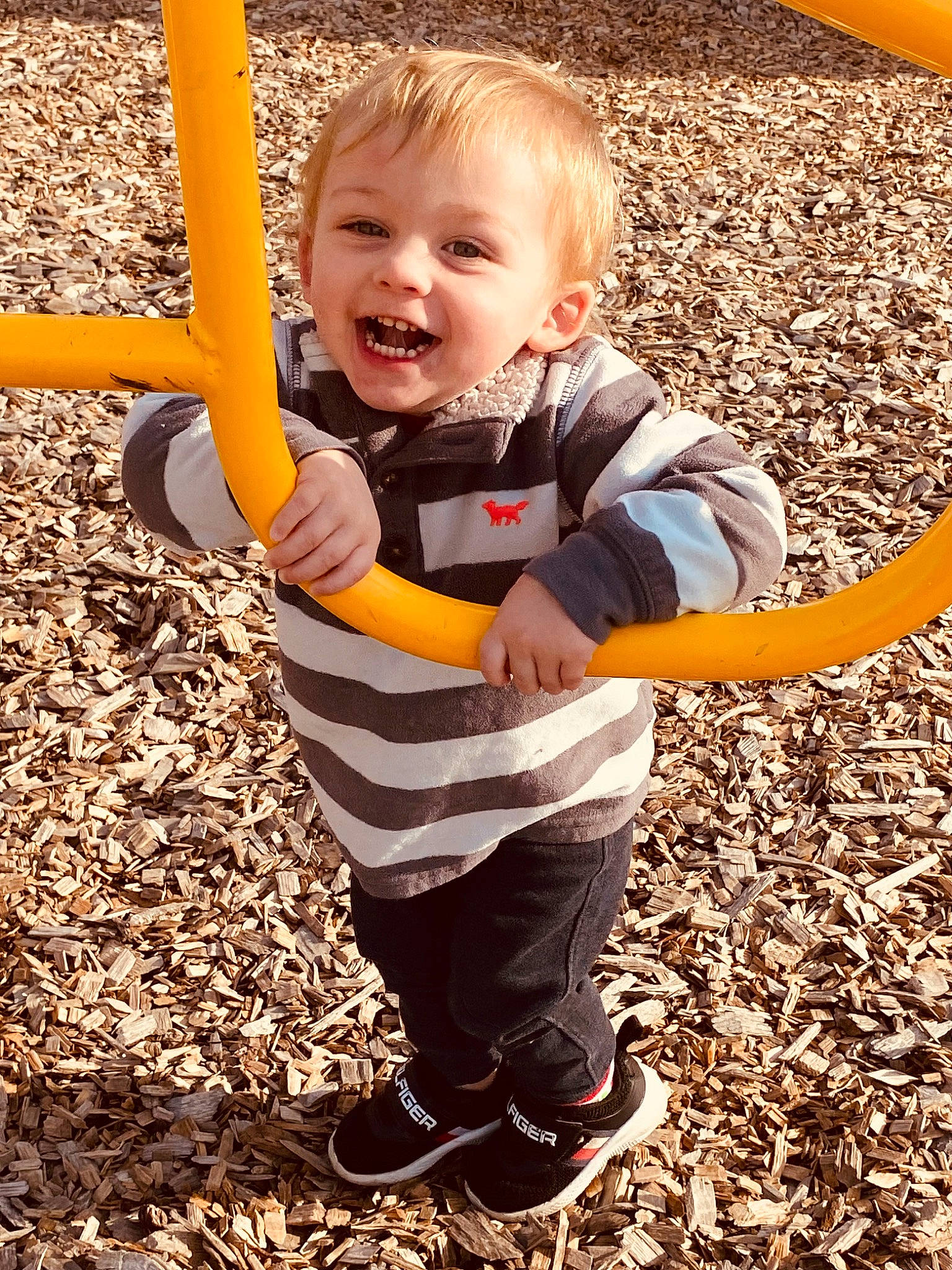 Major is registered to the contest to win money with this photo: baby, baby_toddler_clothing, child, face, fun, grass, hand, happy, leg, outdoor_play_equipment, people_in_nature, person, playground, recreation, sleeve, smile, sneakers, soil, toddler, wood