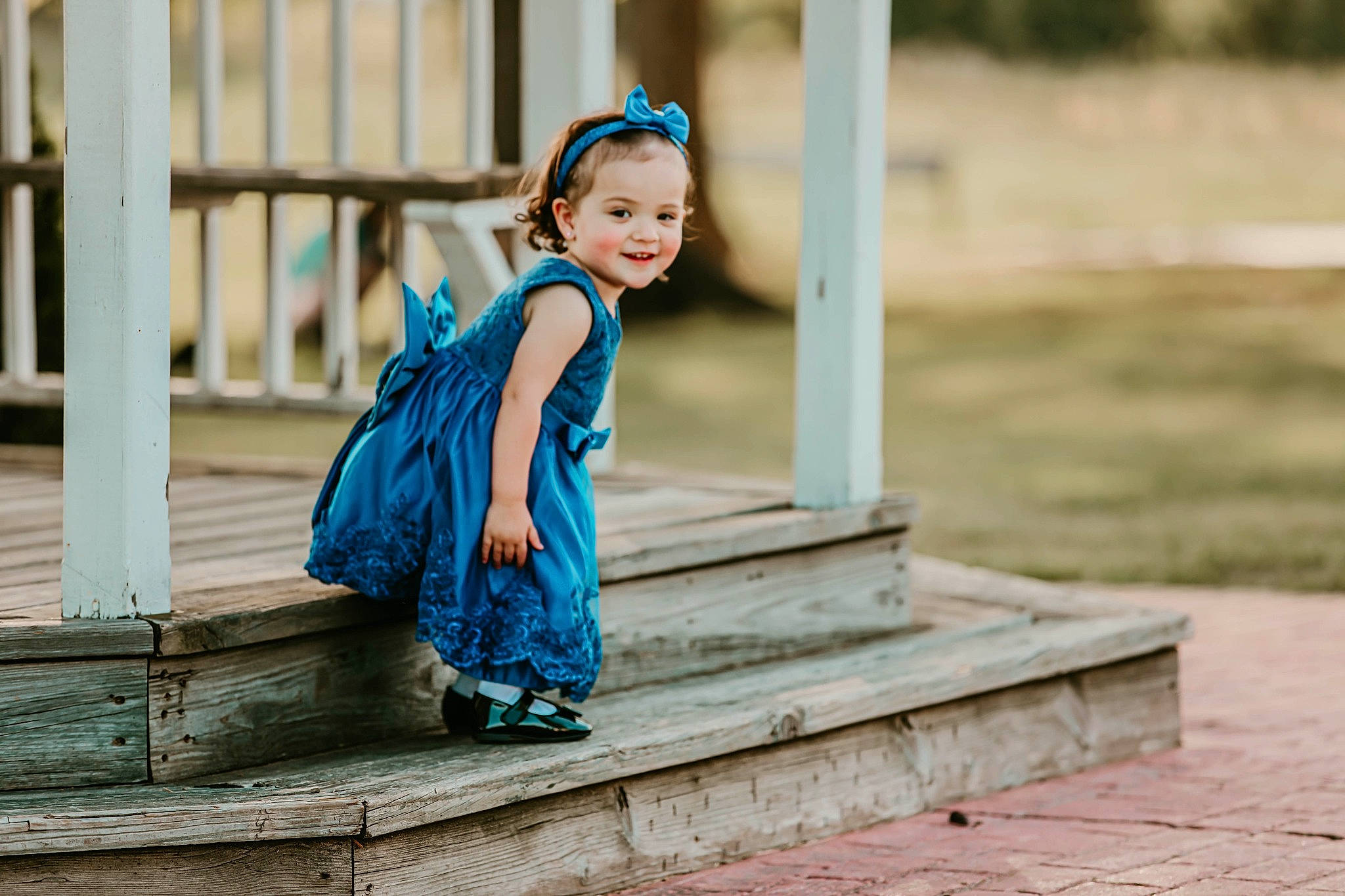 Gianna is registered to the contest to win money with this photo: child, dress, electric_blue, flash_photography, fun, grass, happy, human_leg, joy, leisure, pattern, people_in_nature, person, photo_shoot, portrait_photography, sandal, shoulder, sitting, smile, toddler