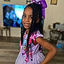 Nevaeh is registered to the contest to win money with this photo: child, girl, braided_hair, beads, purple_bow, lavender_dress, unicorn, smile, portrait, indoor, living_room, television, wall_art, wooden_floor, furniture, person, happy, fashion, cute, colorful