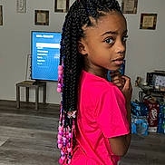 Nevaeh joined the competition — help win amazing prizes! child, girl, braids, beads, butterfly_charm, pink_shirt, living_room, television, flooring, furniture, decor, person, hairstyle, indoor, curious_expression, standing, home, casual_clothing, portrait, young