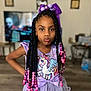 beads, bow, braids, child, cute, fashion, floor, furniture, girl, hair_accessories, indoor, living_room, person, pose, pout, purple_dress, smile, television, unicorn, wall_art
