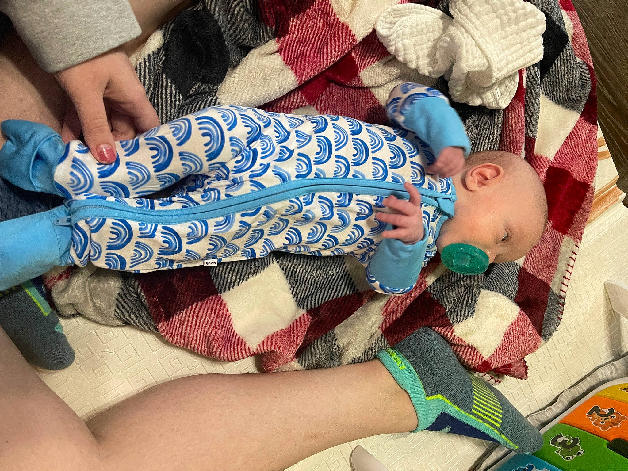 Nikolai is registered to the contest to win money with this photo: baby, baby_products, baby_sleeping, baby_toddler_clothing, blue, child, comfort, electric_blue, human_body, human_leg, knee, lap, linens, nail, pattern, person, sleeve, thigh, thumb, toddler