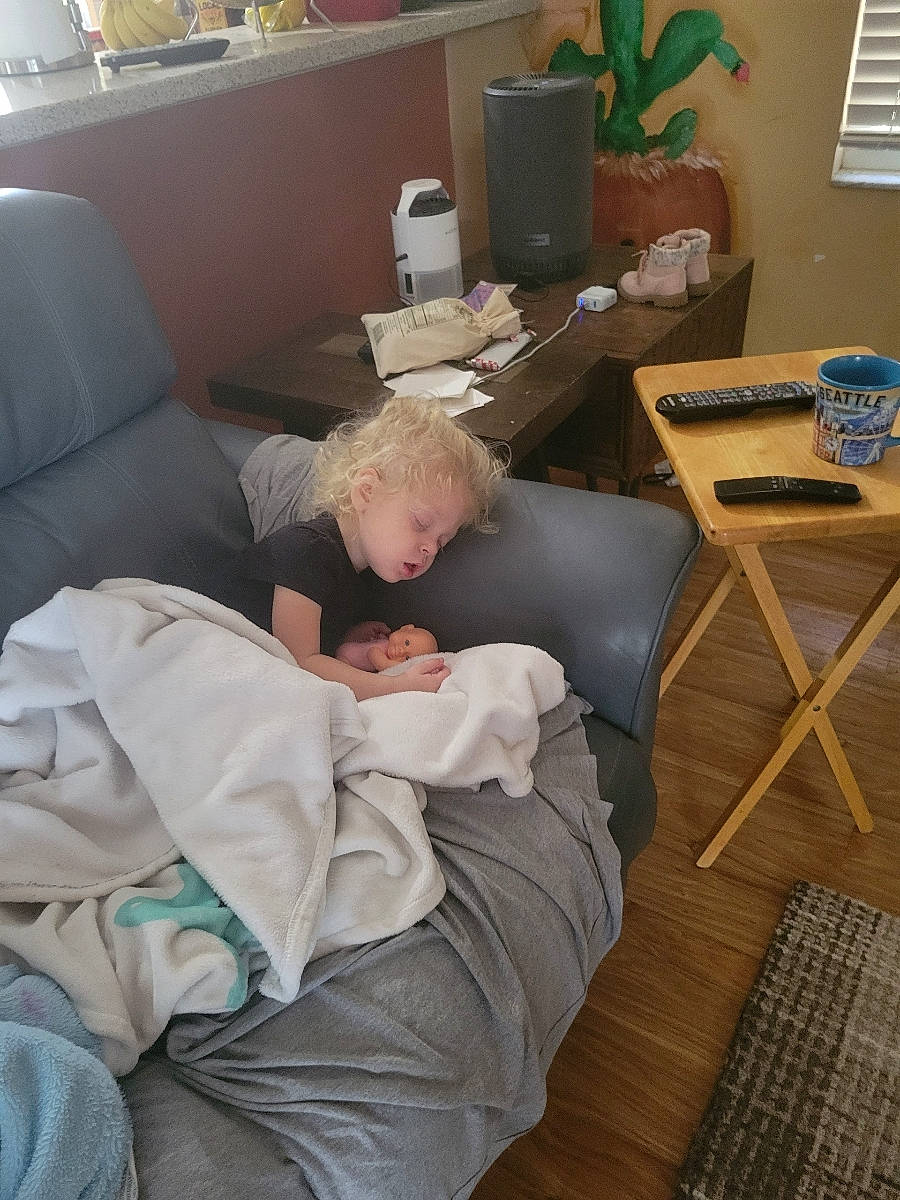 Raelynn joined the competition — help win amazing prizes! baby, comfort, couch, flooring, flowerpot, furniture, hardwood, houseplant, lamp, linens, living_room, person, picture_frame, pillow, plant, room, sitting, table, toddler, window_blind