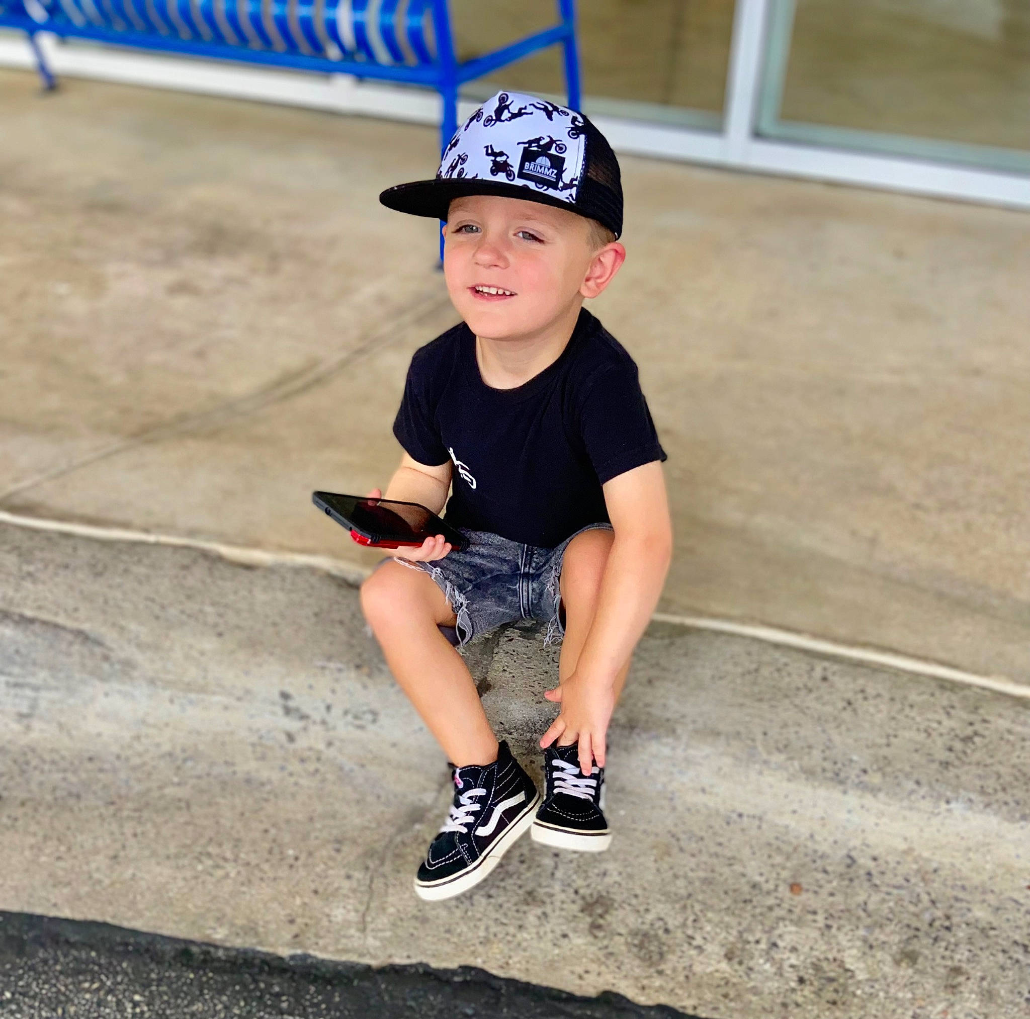 Dawson joined the competition — help win amazing prizes! asphalt, baseball_cap, cap, child, electric_blue, fashion_accessory, fun, happy, hat, headwear, human_leg, joy, knee, leisure, person, personal_protective_equipment, recreation, shorts, sitting, sleeve