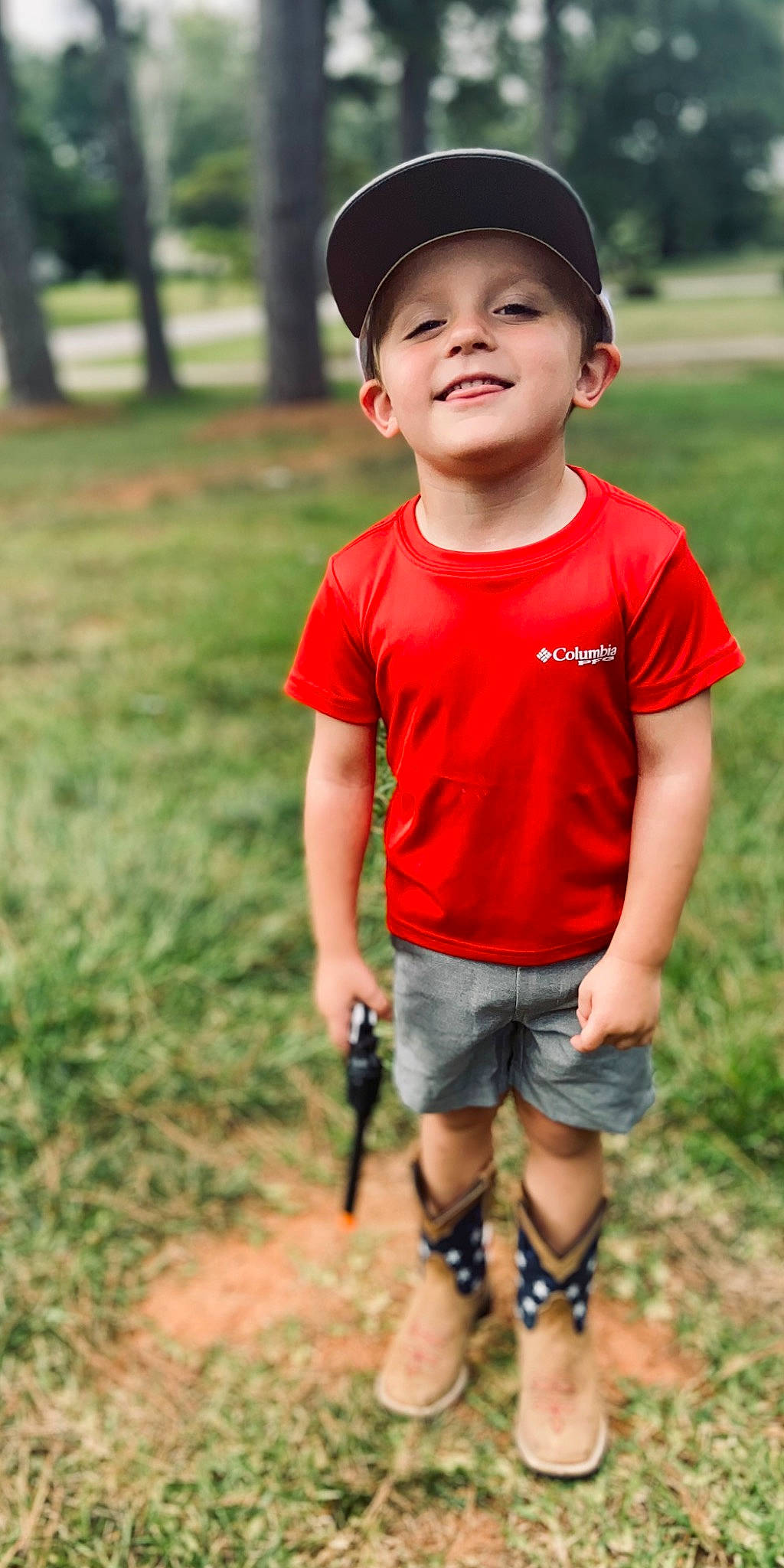Dawson is registered to the contest to win money with this photo: baby_toddler_clothing, cap, child, chin, cool, face, flash_photography, fun, grass, happy, head, headwear, joy, leisure, people_in_nature, person, plant, shorts, sleeve, smile