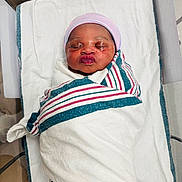 Denise joined the competition — help win amazing prizes! baby, bassinet, bed, blanket, cap, cloth, cute, face, hospital, hospital_room, infant, newborn, peaceful, person, portrait, puckered_lips, sleeping, striped_blanket, swaddled, wrapped