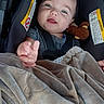 Michael is registered to the contest to win money with this photo: baby, car_seat, blanket, plush_toy, child, infant, smiling, reaching_hand, safety_strap, cozy, indoor, cute, comfortable, young_child, portrait, clothing, seat, resting, happy, soft