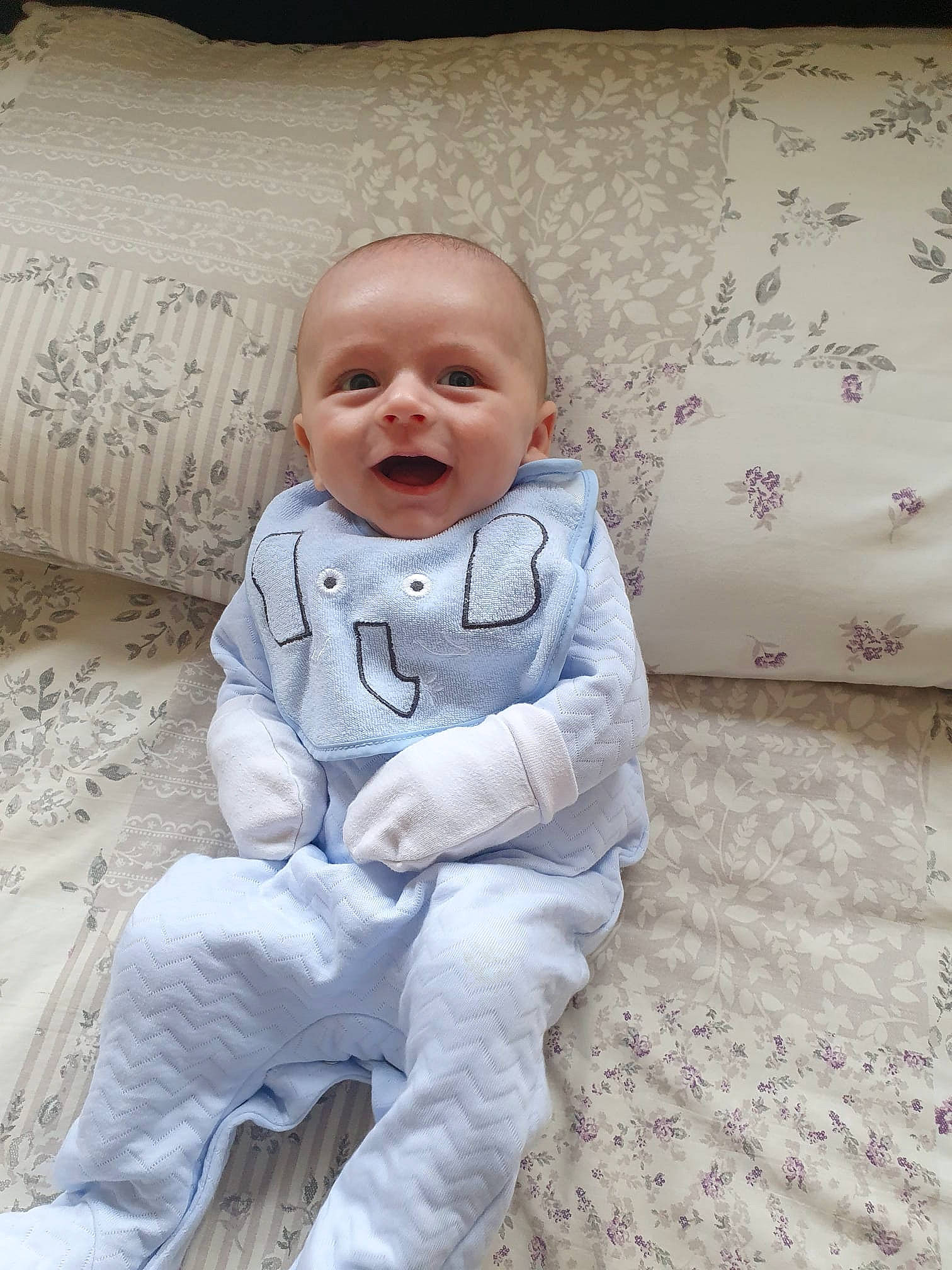 Jamie is registered to the contest to win money with this photo: art, baby, baby_toddler_clothing, cheek, child, comfort, facial_expression, floor, flooring, fun, happy, linens, person, pillow, sitting, skin, sleeve, smile, textile, toddler