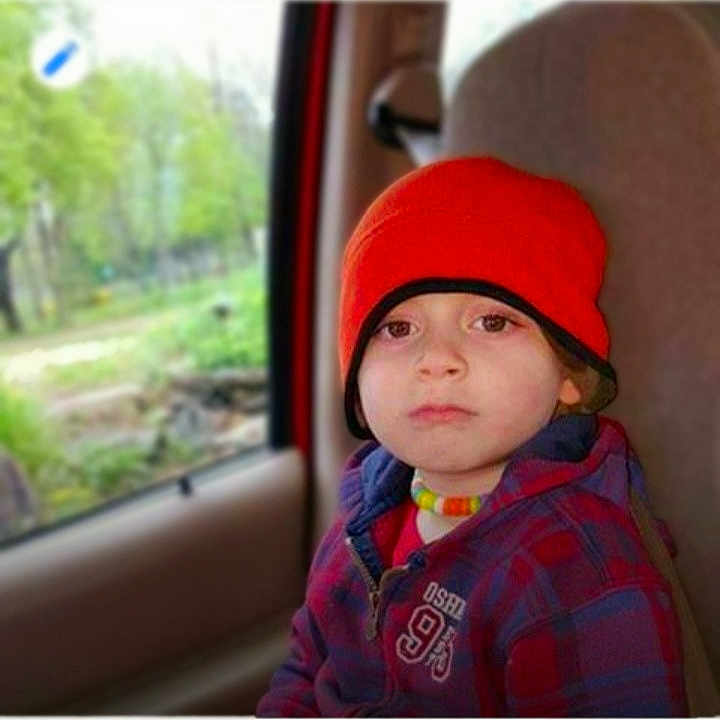 Bryson joined the competition — help win amazing prizes! child, toddler, car_seat, red_beanie, necklace, jacket, plaid, window, car_interior, seat, serious_expression, portrait, young_child, face, person, outdoor_background, nature, casual, travel, autumn_wear