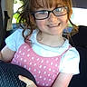 child, girl, glasses, smile, car, seat, pink_dress, white_shirt, hair, hand, portrait, happy, indoors, vehicle, young, casual_clothing, person, childhood, cute, playful