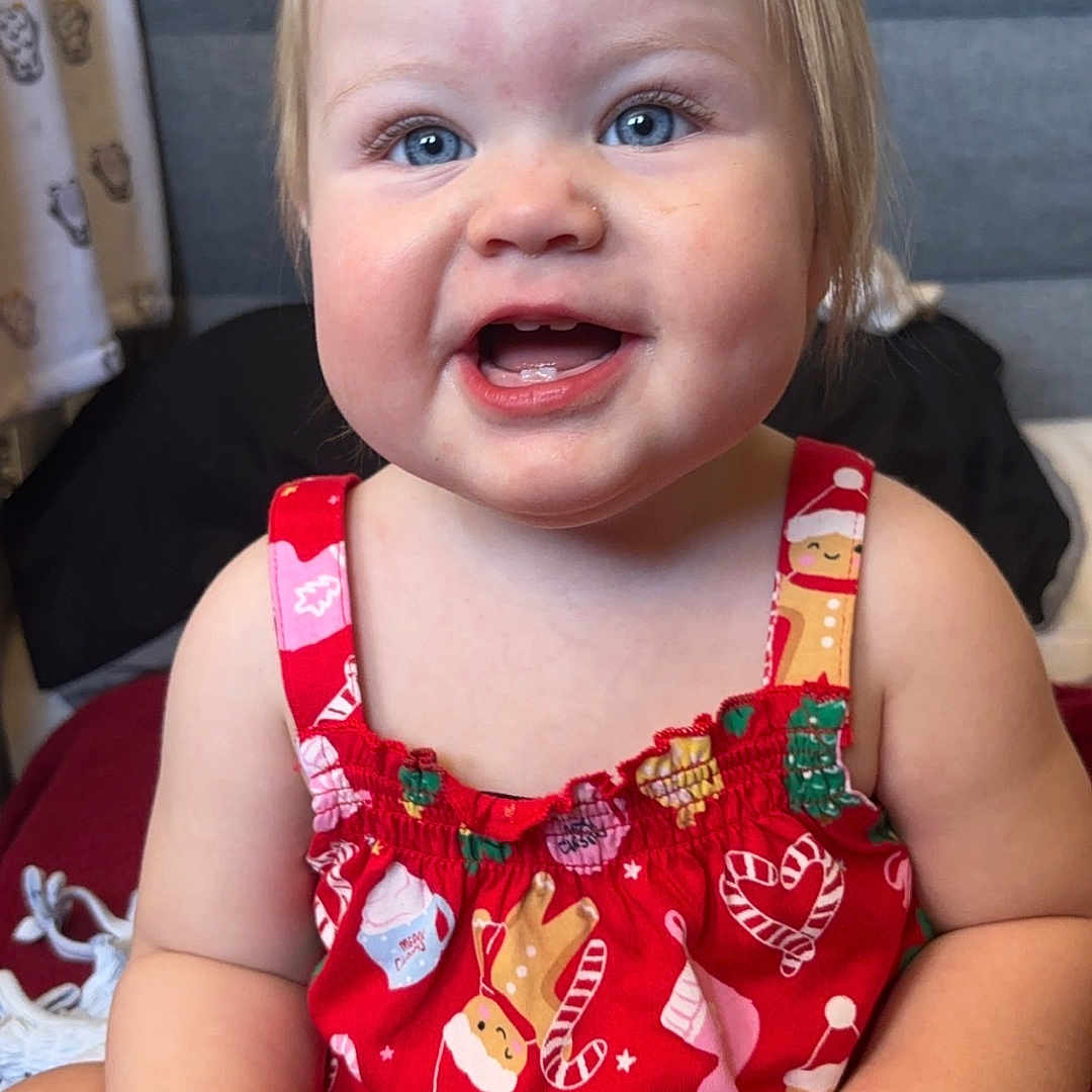 Ashanti joined the competition — help win amazing prizes! accessories, baby, babylaughing, bodypart, clothing, couch, dress, face, happy, head, jewelry, laughing, mouth, necklace, person, photography, portrait, sitting, smile, teeth