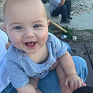 Marcelo joined the competition — help win amazing prizes! baby, smiling, blue_eyes, gray_shirt, person, man, phone, outdoor, stone_wall, concrete, steps, grass, jeans, hand_holding, happy, infant, casual, daylight, sitting, yard