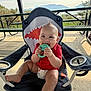 Marcelo is registered to the contest to win money with this photo: baby, child, teething_toy, shark_chair, red_shirt, diaper, outdoor, picnic_table, mountain, nature, smiling, happy, cute, grass, sunlight, park, seat, playful, infant, summer