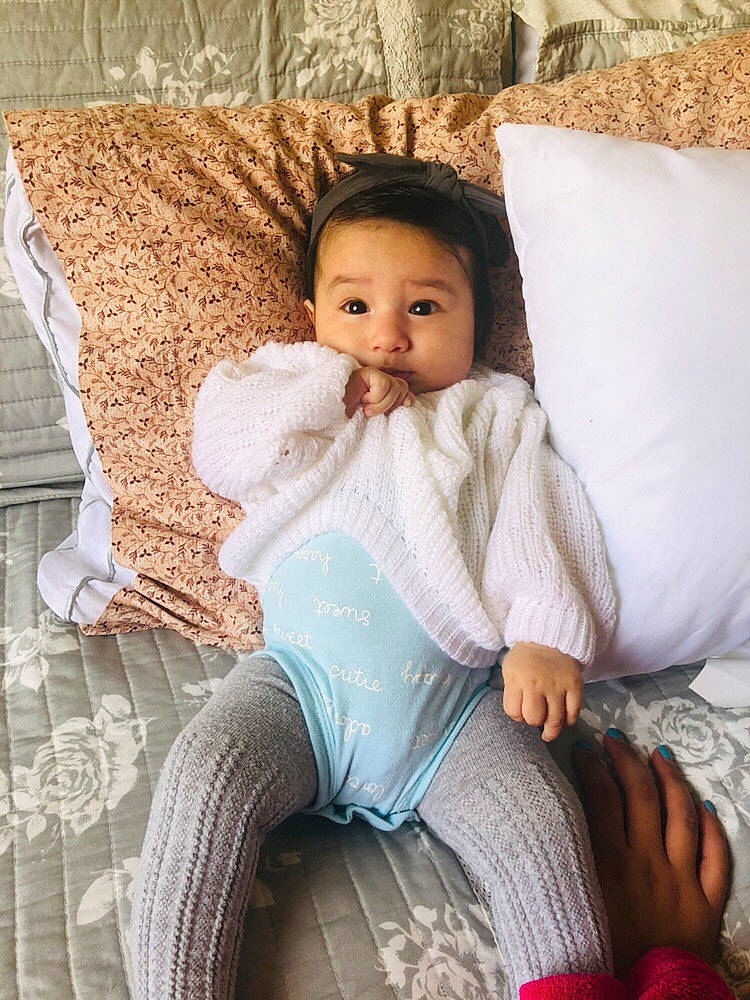 Jayleen is registered to the contest to win money with this photo: baby, bedding, child, comfort, cushion, furniture, person, pillow, sitting, textile, toddler