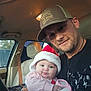 Emberlee joined the competition — help win amazing prizes! baby, man, car, seat, seatbelt, hat, santa_hat, blanket, clothing, portrait, indoor, person, smile, facial_hair, cross_necklace, holding, window, daylight, headwear, casual