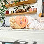 baby, blue_eyes, books, child, curious, cute, decor, floor, flower, guitar, headband, home, indoor, plants, portrait, shelves, smile, soft_lighting, vintage_suitcase, white_clothing